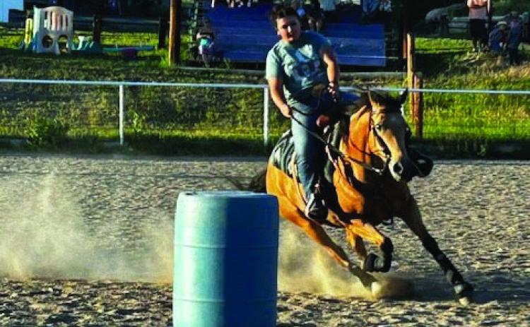 RCC Saddle Club members are enjoying Thursday evening gymkhanas. Here Ashlynn Cozzetto guides her horse around the barrel pattern. Courtesy Photo