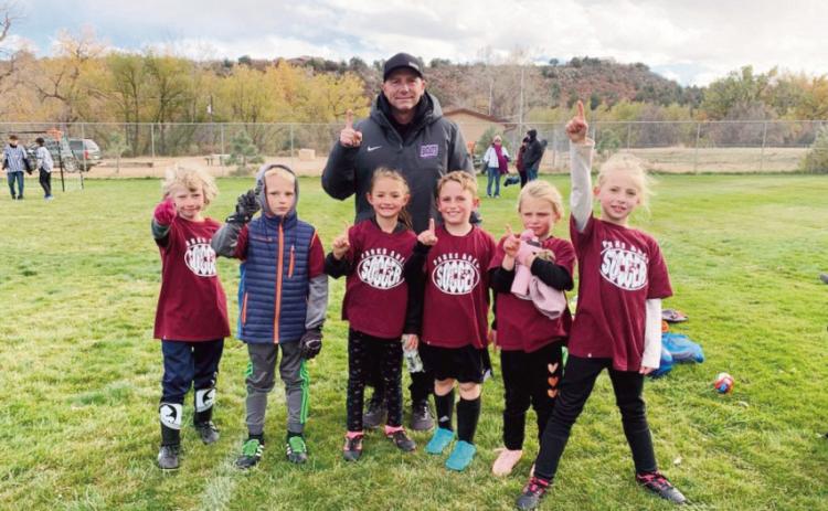 John Crowell with the eight-year-old soccer team he coached in Colorado City last fall.